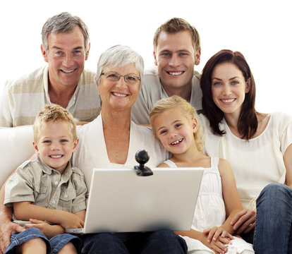 Happy family using a laptop at home