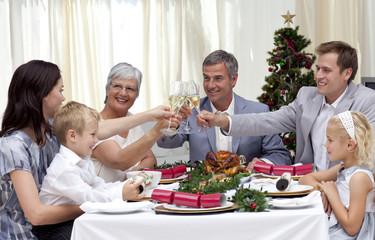 Family drinking a toast in a Christmas dinner