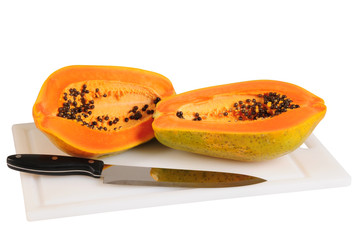 Papaya on cutting board. Clipping path.