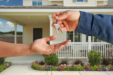 Handing Over the House Keys in Front of New Home