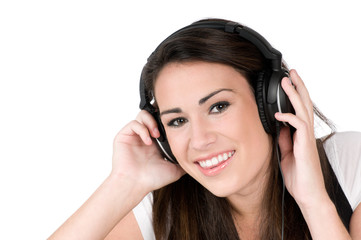 Young woman listening to music on headphones, isolated on white