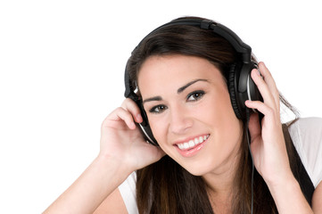 Fototapeta premium Young woman listening to music on headphones, isolated on white