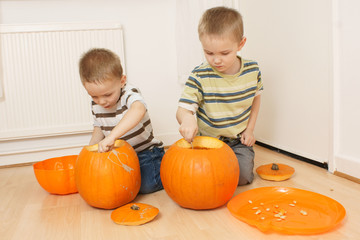 Fototapeta premium boys scooping pumpkins