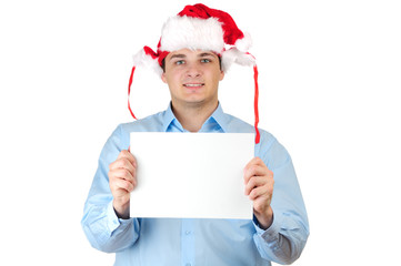 Young man in Santa's hat holding a blank card