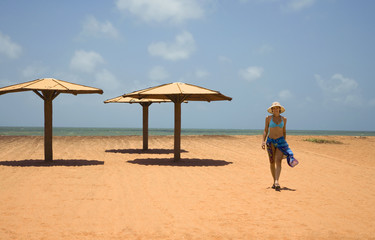 Young woman walking along the beach