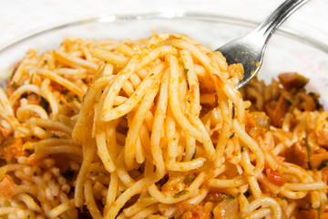 Pasta with fork in it isolated on white