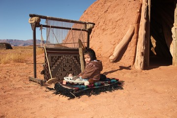 Navajo Child Sitting Next to Traditional Rug Making Tools - obrazy, fototapety, plakaty