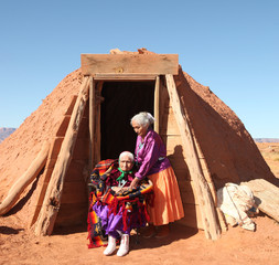 2 Navajo Women Outside Their Traditional Hogan Hut - obrazy, fototapety, plakaty