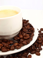 Cup of coffee with coffee beans isolated on white