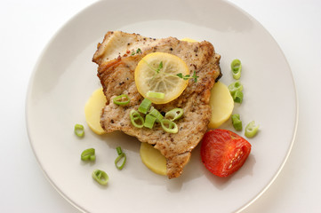 carp steak with potato and organic tomato