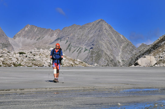 Young man walking on high mountain sandur