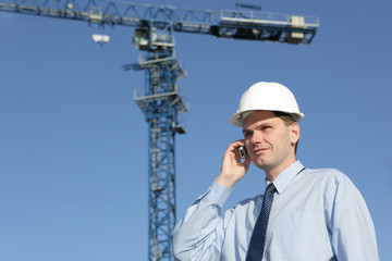 Engineer talkin by phone on a construction site