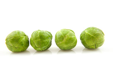 Four Brussels sprouts over white background