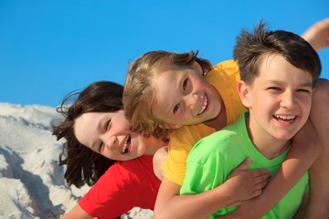 Siblings playing on beach