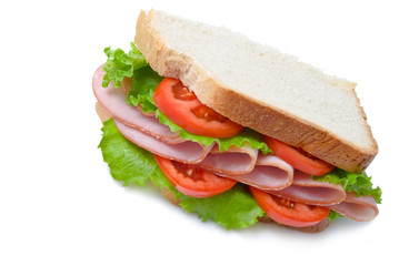 sandwich with sliced ham, tomatoes and lettuce leaves