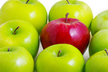 Background of green apples with one red apple