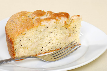 slice of lemon poppy seed cake with a fork