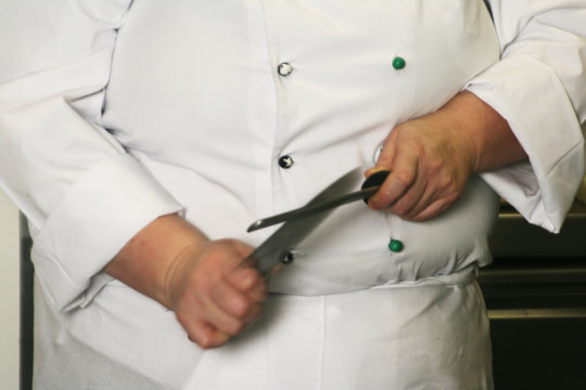 Chef Sharpening a Knife