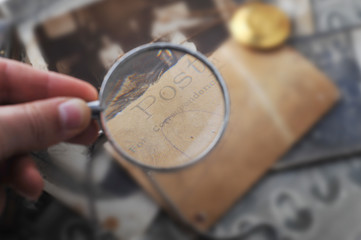 hand with reading-glass and  Post card