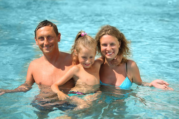 mother, father and kid swimming