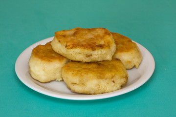 Potato cakes with meat on a green background