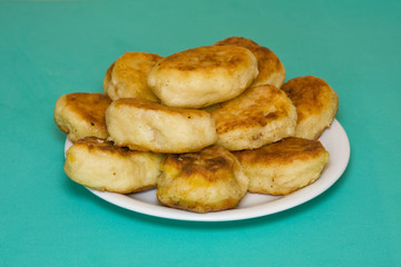 Potato cakes with meat on a green background