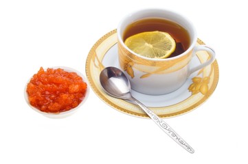 a cup of tea with lemon and jam in a bowl