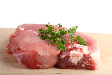 Piece of crude meat with spices. It is isolated.