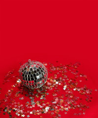 Discoball and confetti over red