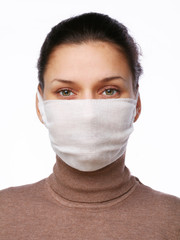 Young woman in medical mask on a white background