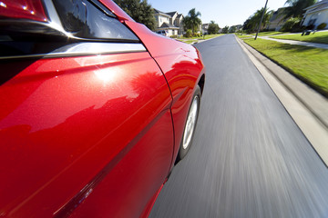 Car Driving at Speed on Suburban Street