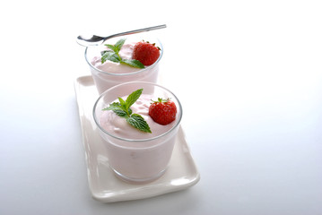 one organic strawberry in yogurt and mint