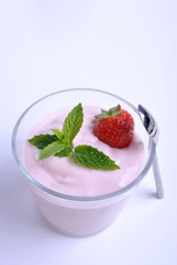 one organic strawberry in yogurt and mint