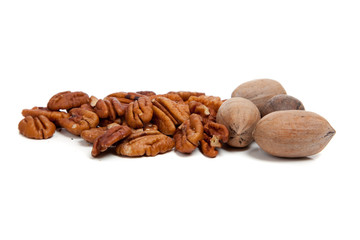 Whole and halved pecans on white