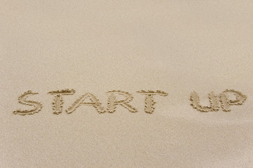 Start up written in sandy beach