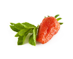 Ripe strawberry with a fresh leaf of mint on a white background