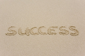 Success written in sandy beach