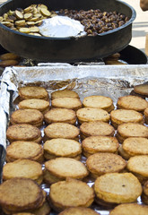 Roasting potato pancakes and chestnuts on a Christmas market