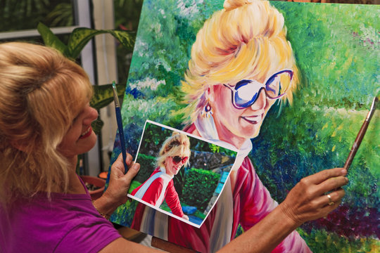 female artist painting a self portrait
