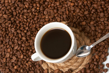 Cup with coffee, costing on coffee grain