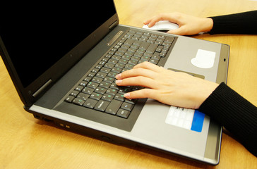 hands typing on laptop