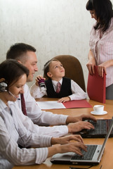 Little boy as an office-chief with employees