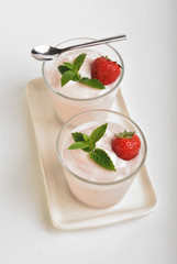 some organic strawberries in natural yogurt and mint
