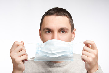 man puttin on protective mask