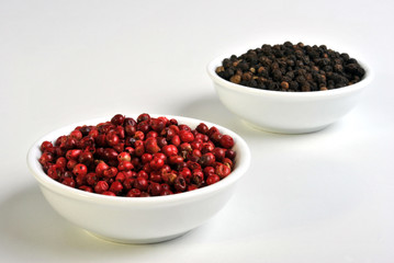 black and red pepper in a white bowl