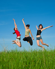 Fototapeta na wymiar Girls jump on the meadow