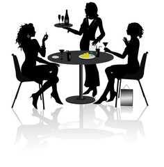 Two beautiful girlfriends sit and talk in Restaurant