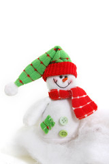 toy snowman in snow over white