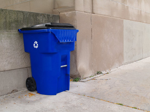Large Blue Trash Can on a City Sidewalk