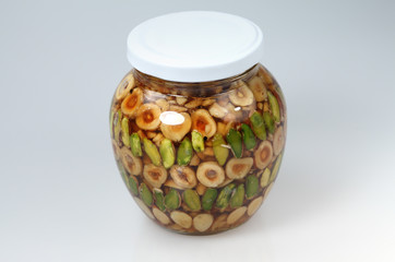 Nuts in honey in glass